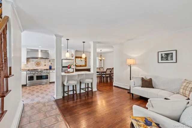a living room with furniture and kitchen view