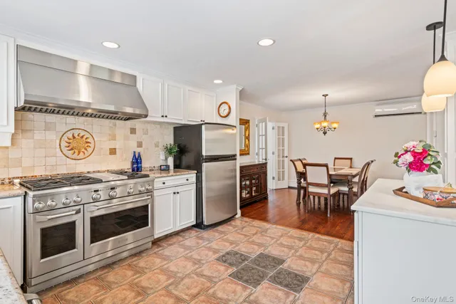 a kitchen with a stove and chairs