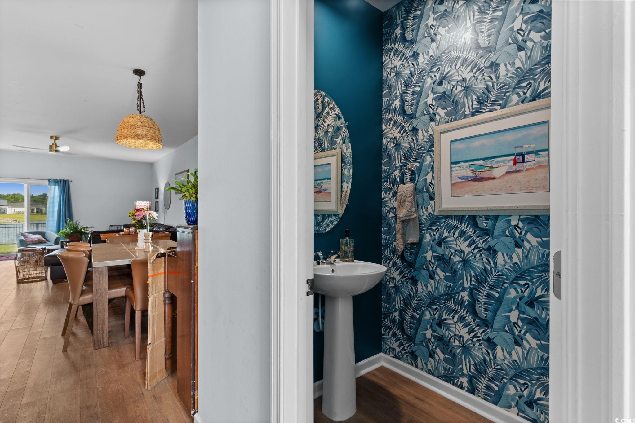 196 Cypress Tree Loop Longs, SC 29568 - Photo 11 of 40 Bathroom featuring wallpapered walls, wood finished floors, baseboards, ceiling fan, and a sink