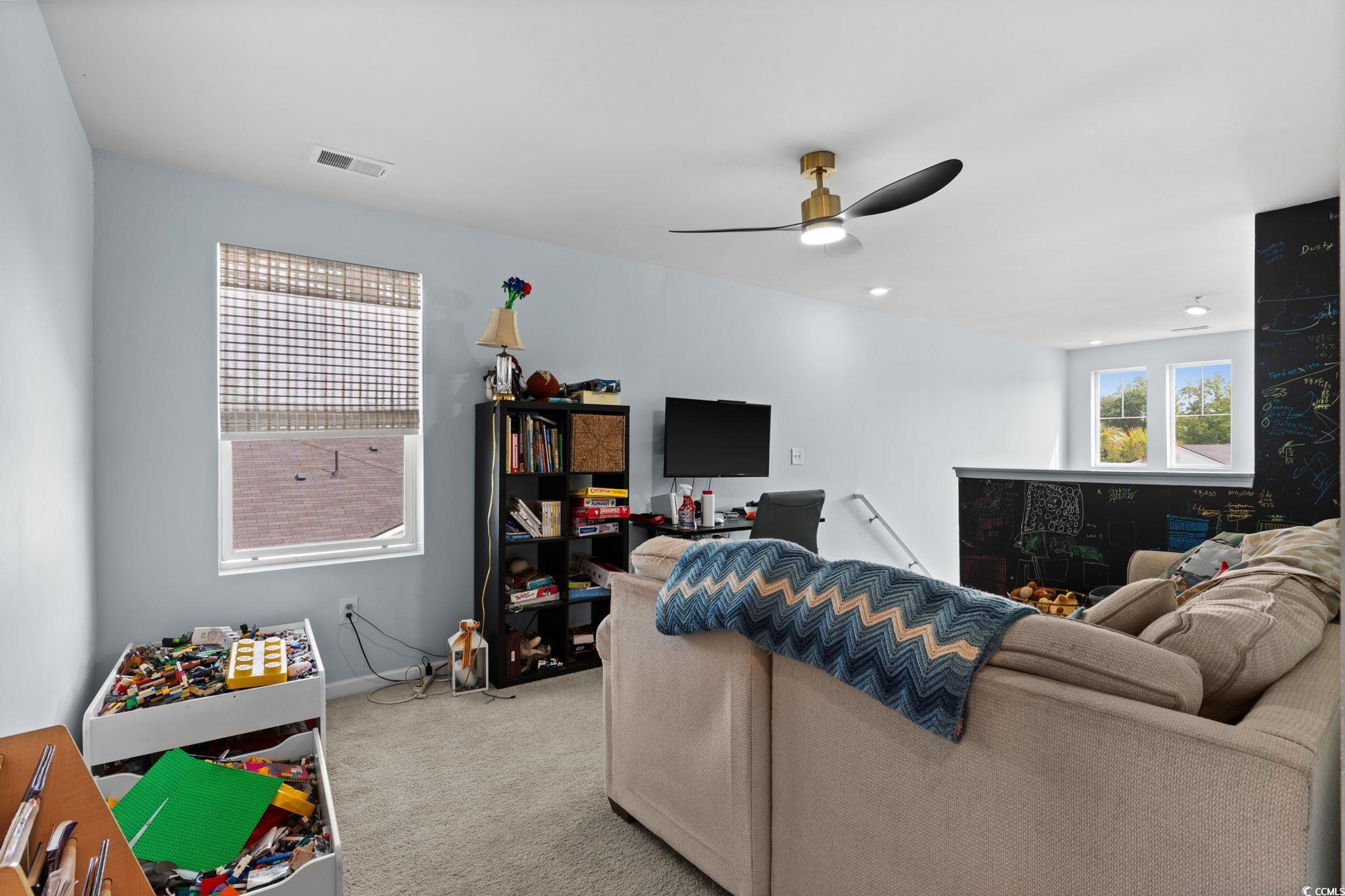 196 Cypress Tree Loop Longs, SC 29568 - Photo 21 of 40 Carpeted living area featuring a ceiling fan and baseboards