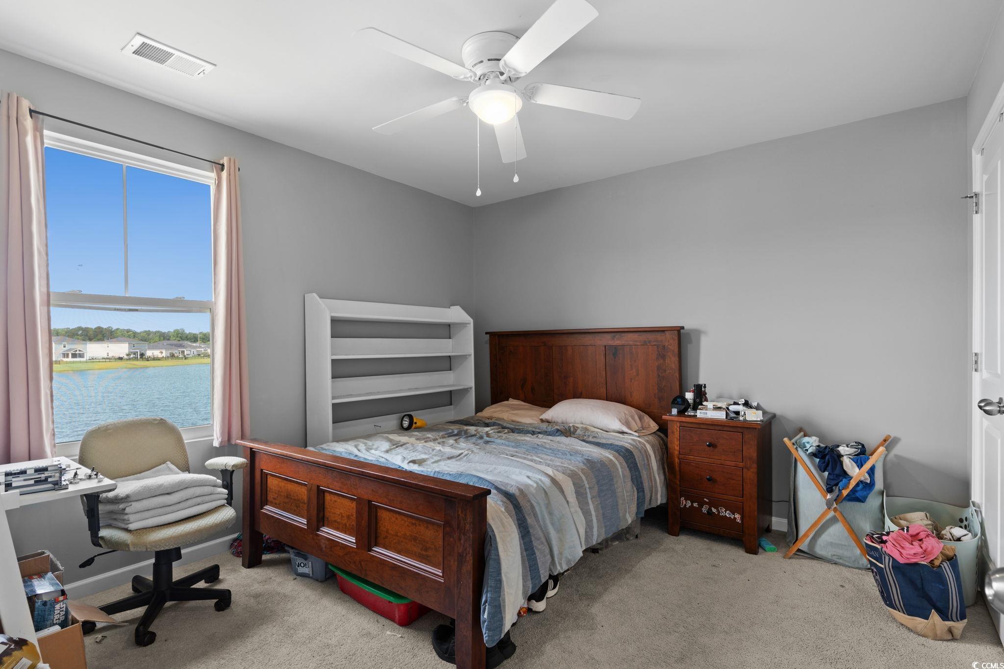 196 Cypress Tree Loop Longs, SC 29568 - Photo 28 of 40 Carpeted bedroom featuring a water view and a ceiling fan