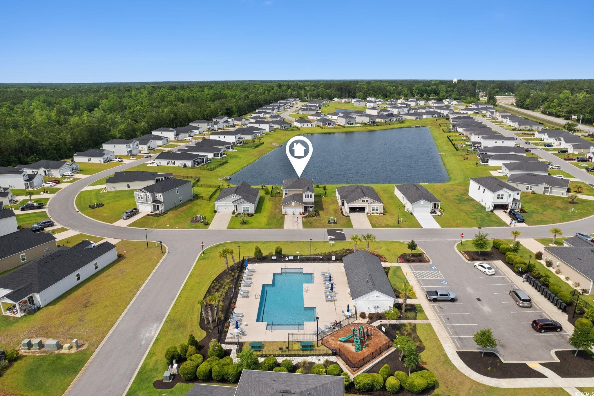 196 Cypress Tree Loop Longs, SC 29568 - Photo 33 of 40 Aerial perspective of suburban area with a pool and a nearby body of water
