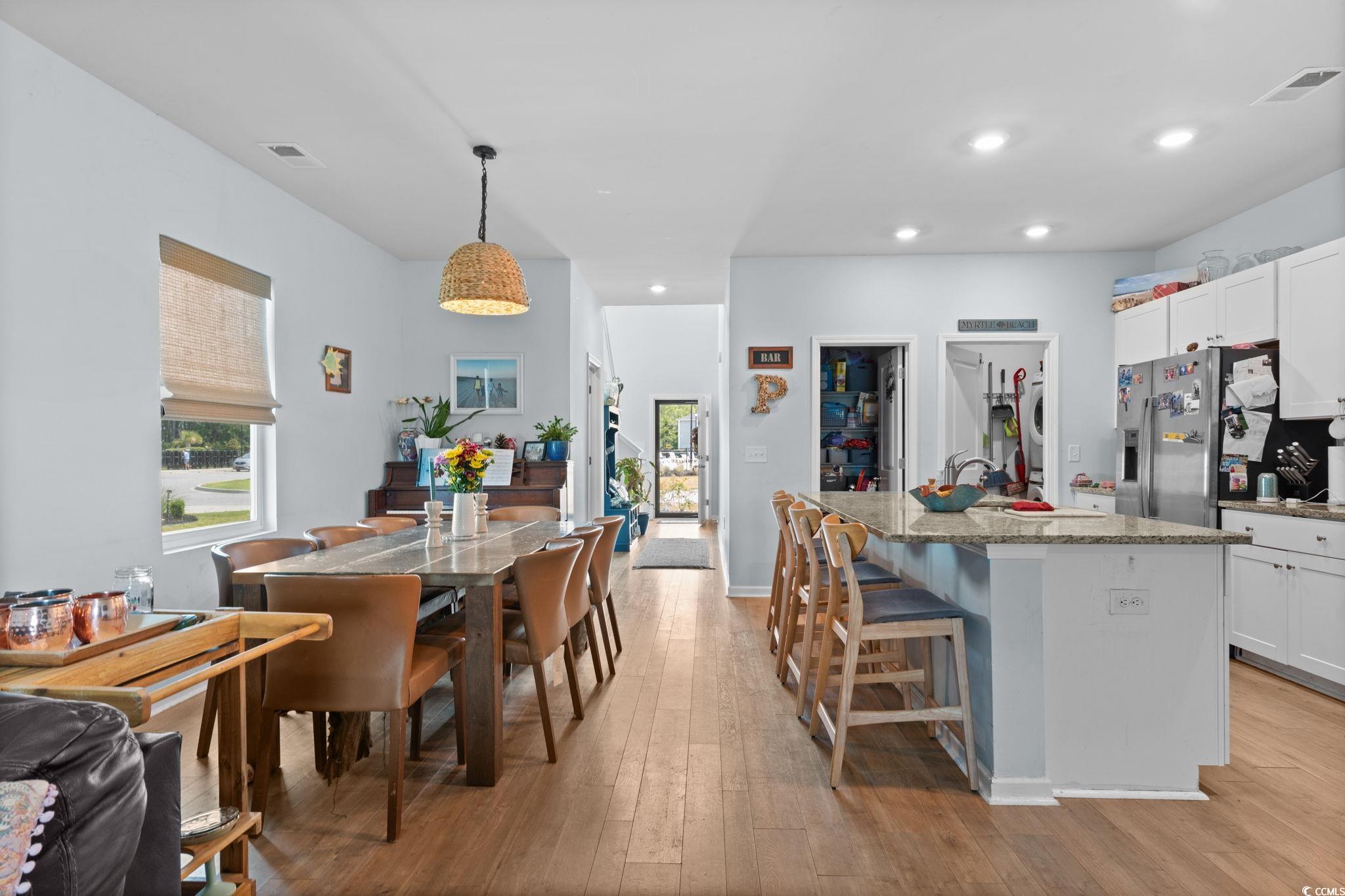196 Cypress Tree Loop Longs, SC 29568 - Photo 4 of 40 Kitchen with stainless steel fridge, light wood finished floors, light stone countertops, healthy amount of natural light, and recessed lighting