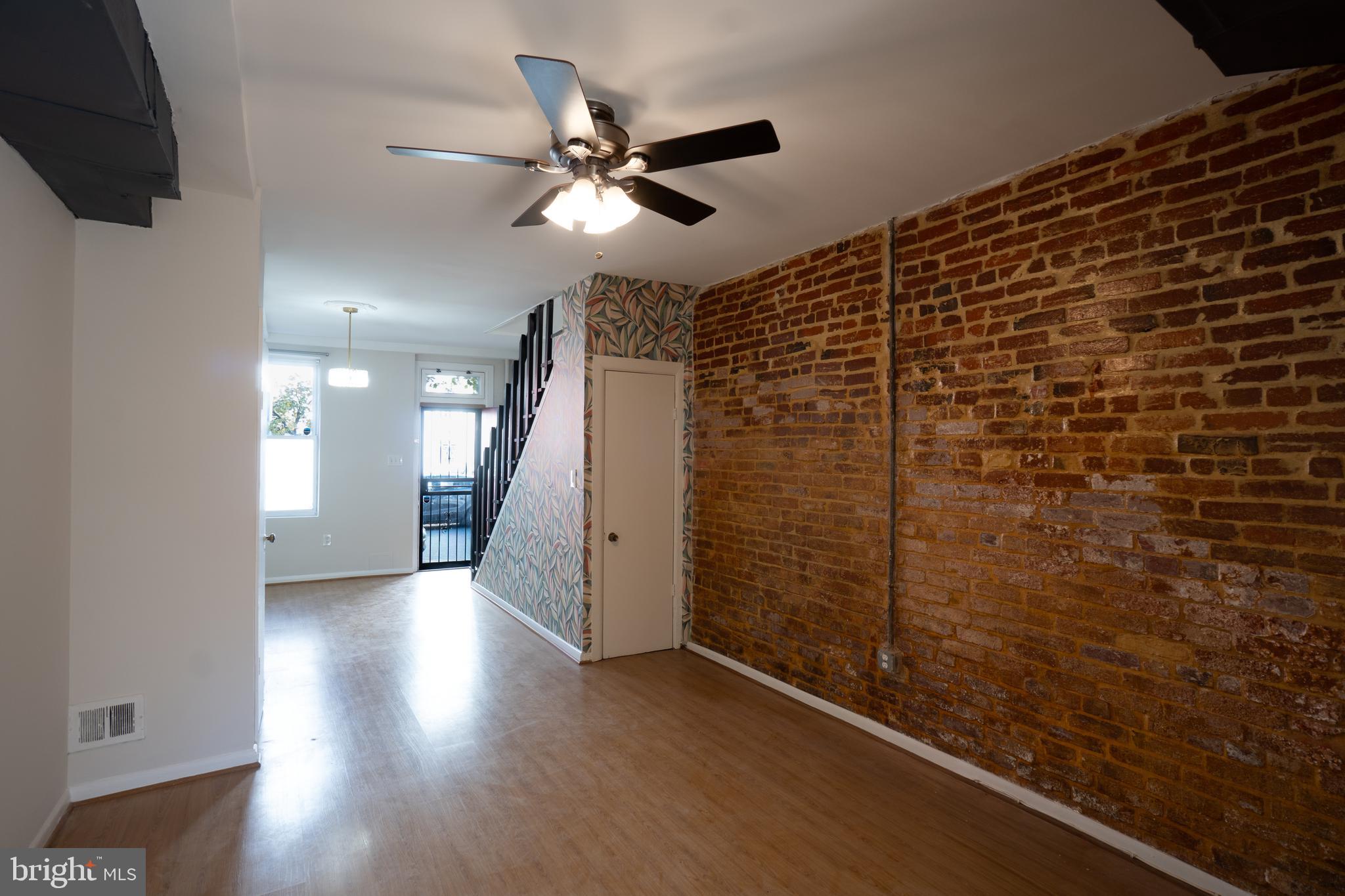 1227 Wylie Street Northeast Washington, DC 20002 - Photo 11 of 20 a view of a hallway with wooden floor and staircase