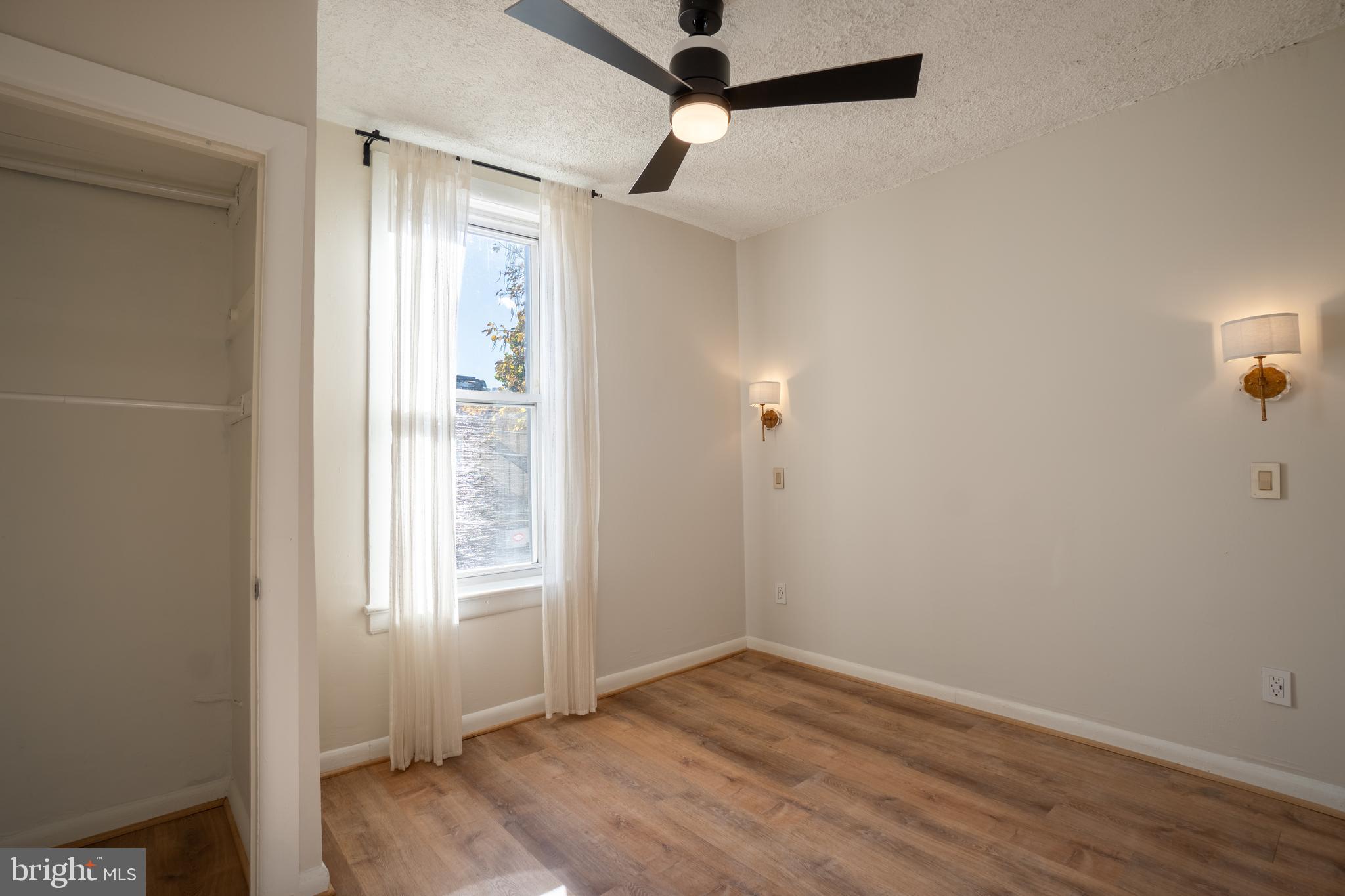 1227 Wylie Street Northeast Washington, DC 20002 - Photo 13 of 20 an empty room with wooden floor cabinet and windows