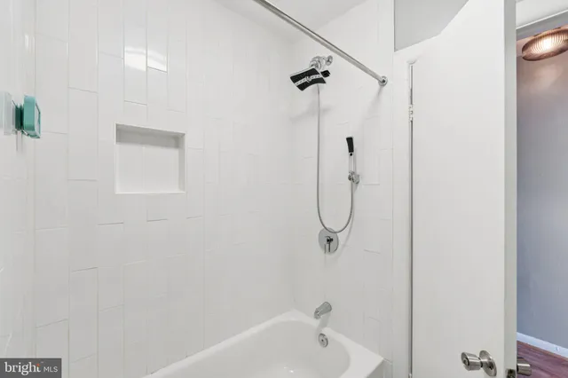 a bathroom with a bath tub with a shower