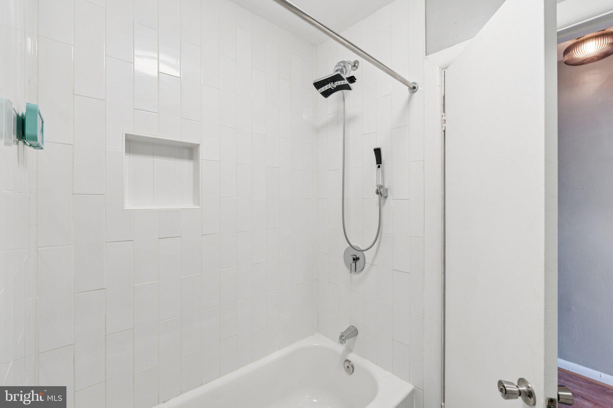 1227 Wylie Street Northeast Washington, DC 20002 - Photo 16 of 20 a bathroom with a bath tub with a shower