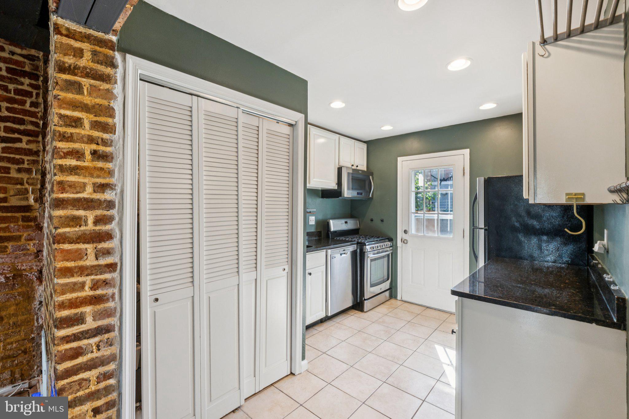 1227 Wylie Street Northeast Washington, DC 20002 - Photo 8 of 20 a kitchen with granite countertop a refrigerator and a sink