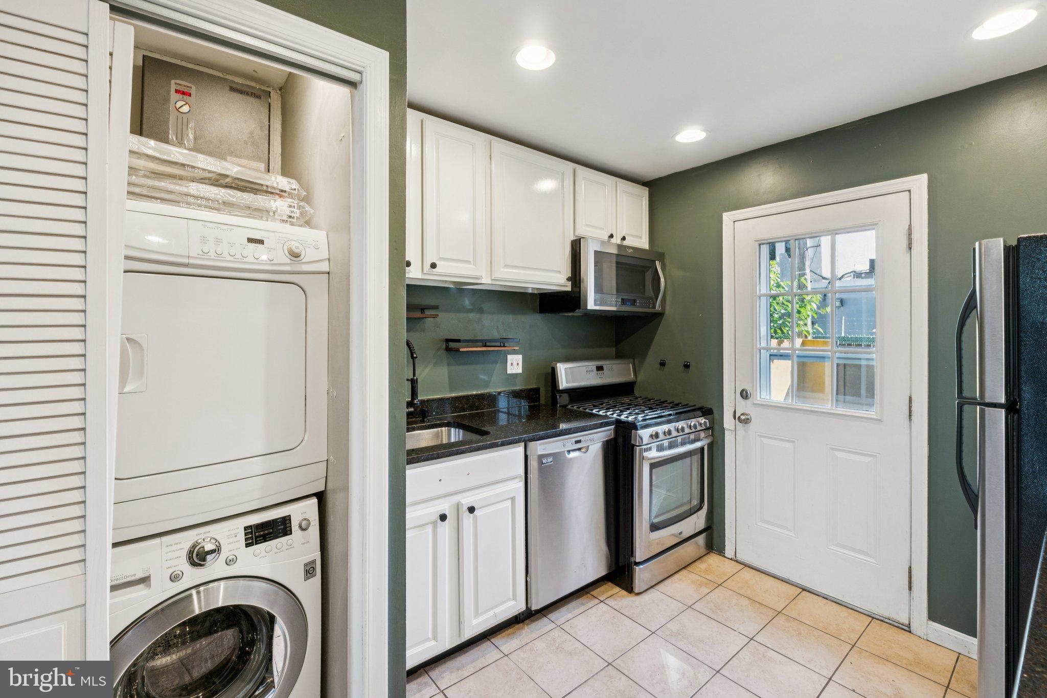 1227 Wylie Street Northeast Washington, DC 20002 - Photo 9 of 20 a kitchen with stainless steel appliances granite countertop a stove a sink and a refrigerator