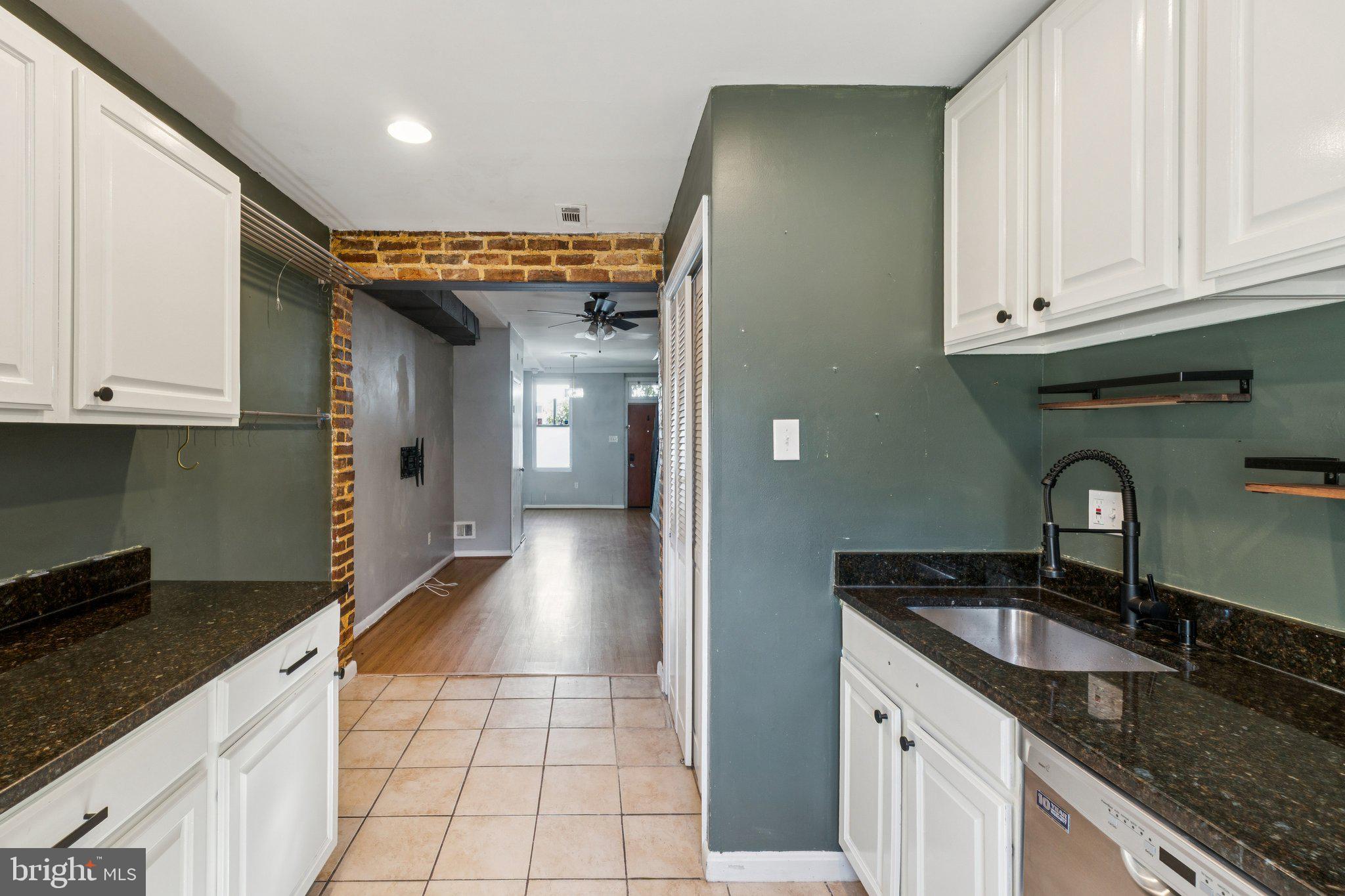 1227 Wylie Street Northeast Washington, DC 20002 - Photo 10 of 20 a kitchen with granite countertop a sink and cabinets