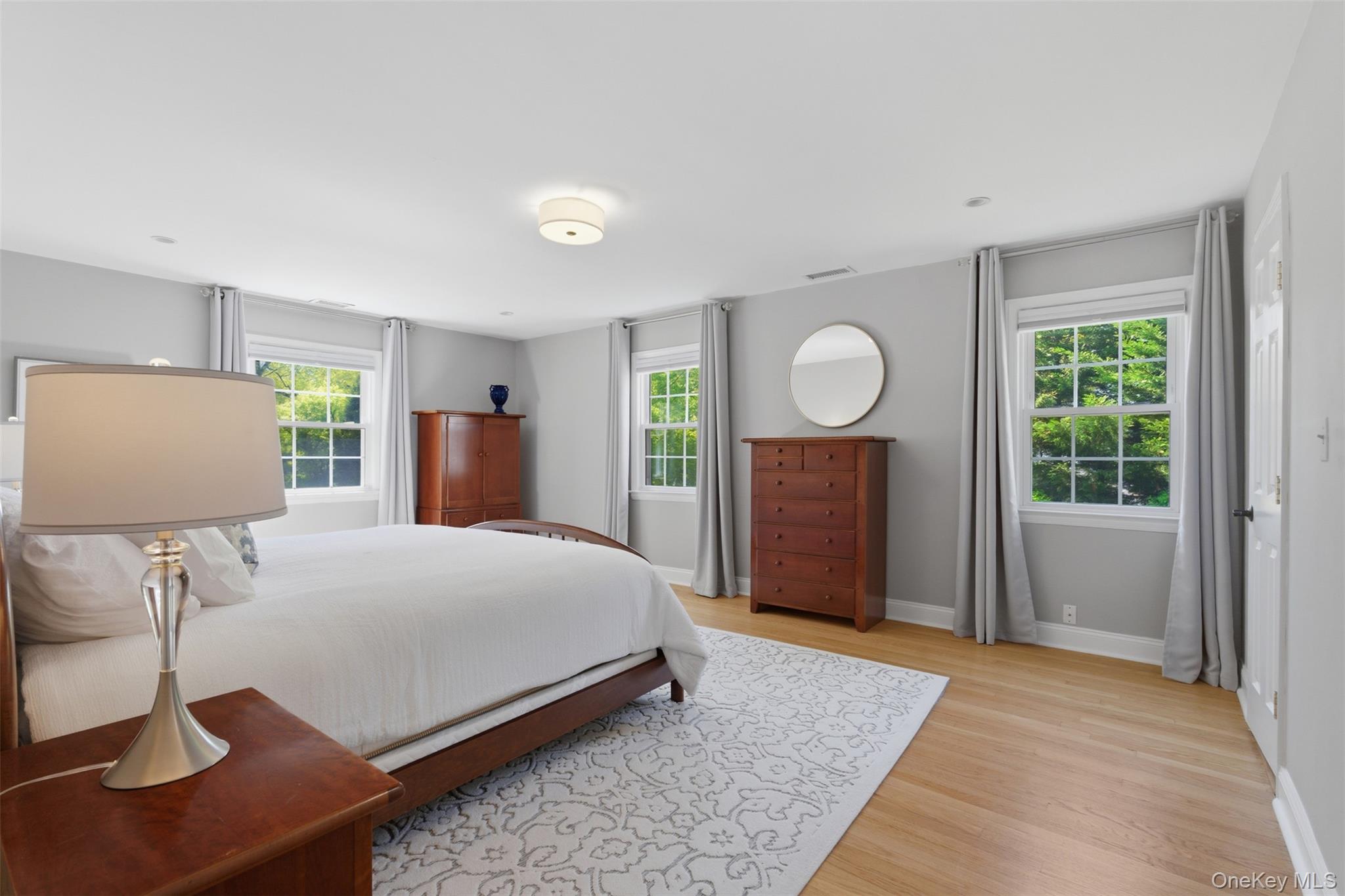 136 Devonshire Road Larchmont, NY 10538 - Photo 15 of 34 a bedroom with a bed and a table in it