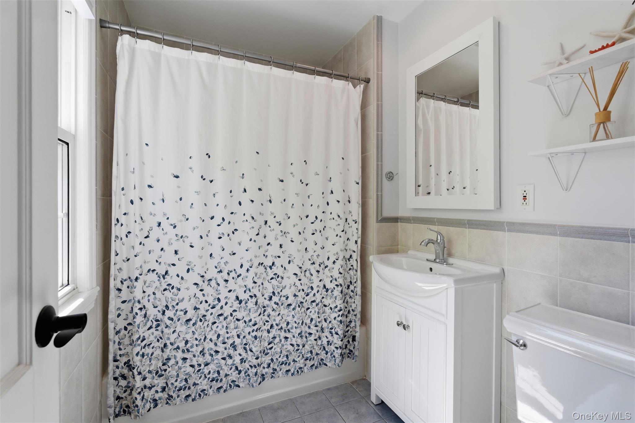 136 Devonshire Road Larchmont, NY 10538 - Photo 21 of 34 a bathroom with a shower curtain and a sink