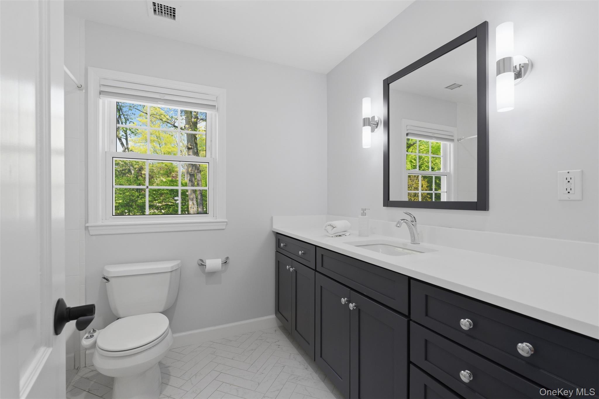 136 Devonshire Road Larchmont, NY 10538 - Photo 28 of 34 a bathroom with a toilet sink and mirror