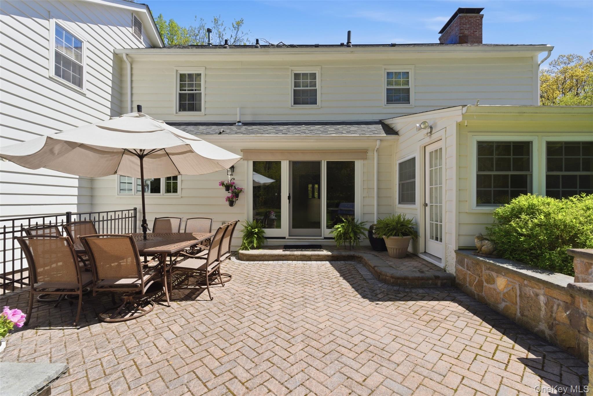 136 Devonshire Road Larchmont, NY 10538 - Photo 31 of 34 a view of a patio with table and chairs near a barbeque