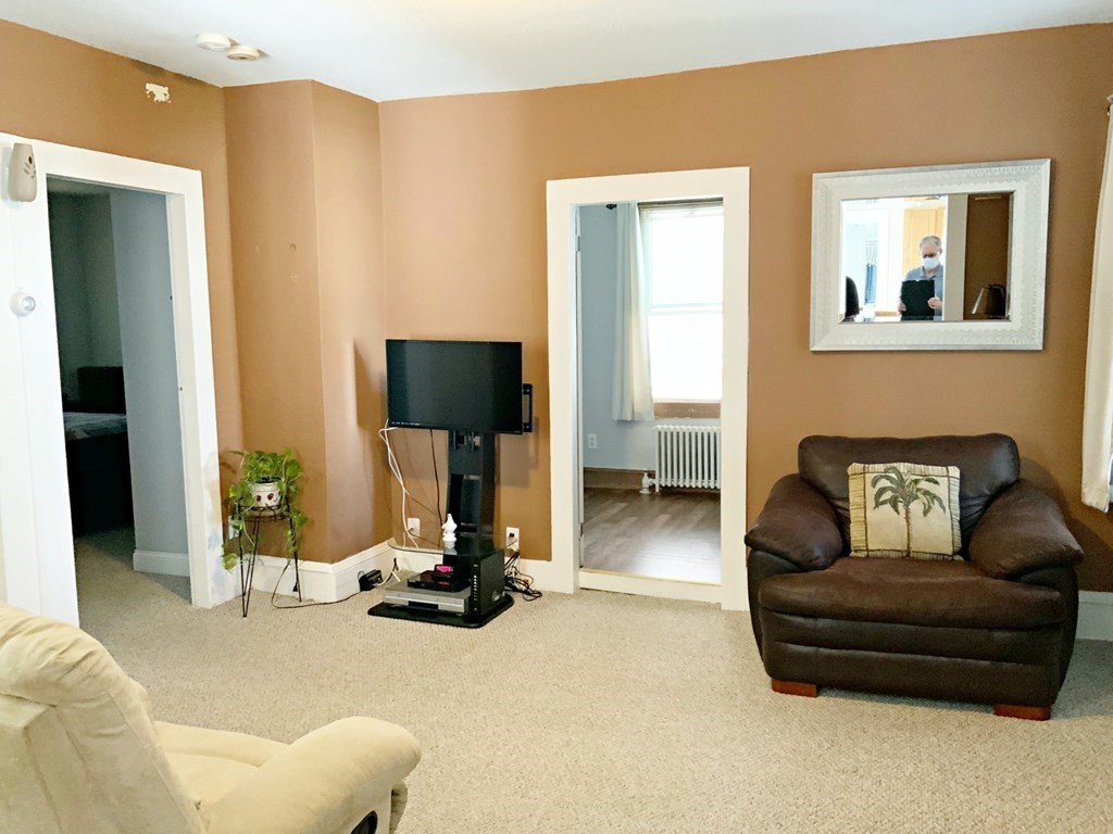 250 Main Street Springfield, MA 01151 - Photo 4 of 20 a living room with furniture gym equipment and a flat screen tv