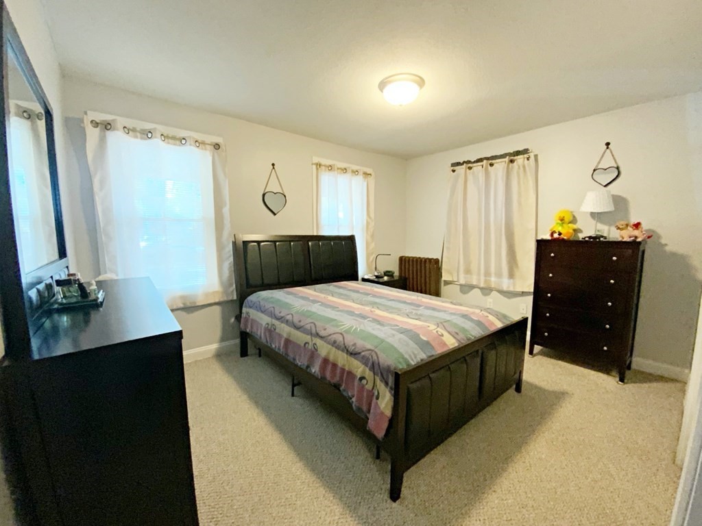 250 Main Street Springfield, MA 01151 - Photo 6 of 20 a bedroom with a bed and a dresser