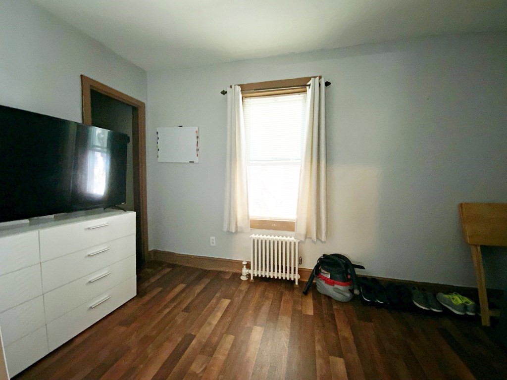 250 Main Street Springfield, MA 01151 - Photo 8 of 20 a room with wooden floor and flat screen tv