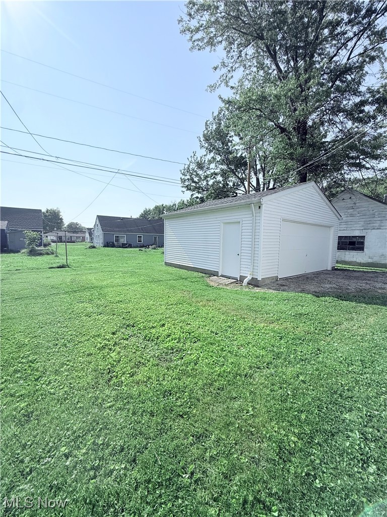 4816 Wake Robin Road Mentor, OH 44060 - Photo 18 of 19 View of grassy yard with a garage and an outbuilding