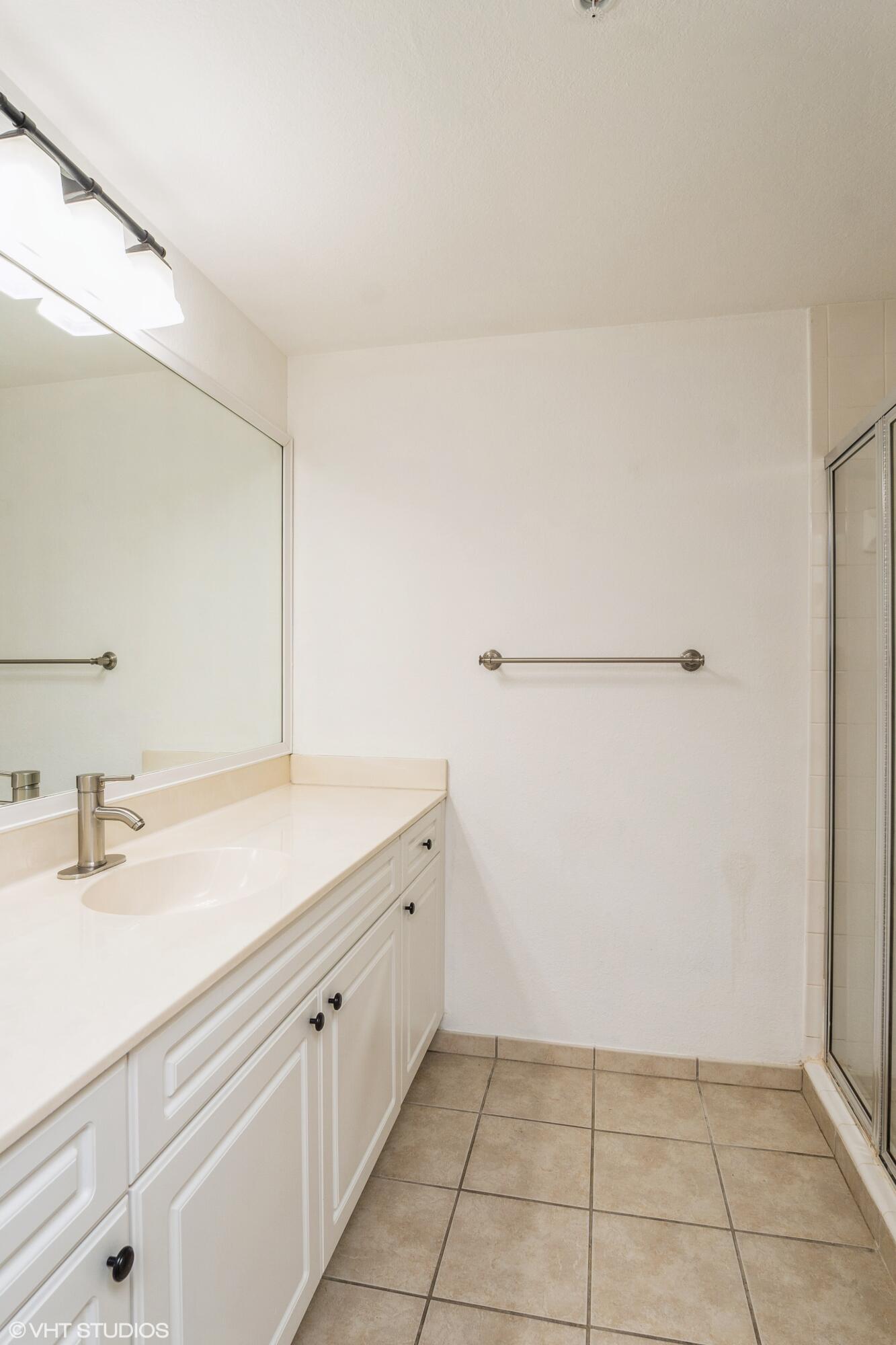 2725 Anzio Court, Unit 102 Palm Beach Gardens, FL 33410 - Photo 13 of 33 a bathroom with a sink and a mirror