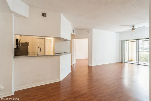a view of a kitchen with wooden floor and a sink
