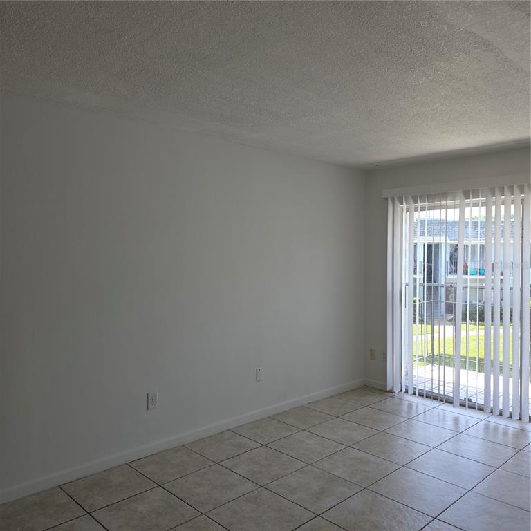 921 West Oak Ridge Road, Unit 921C Orlando, FL 32809 - Photo 2 of 6 an empty room with windows