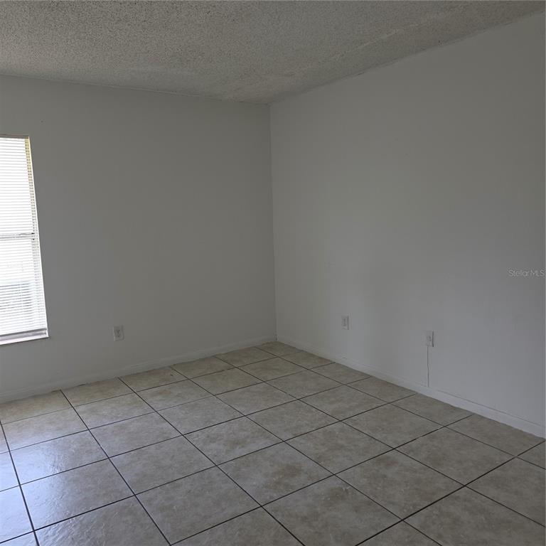 921 West Oak Ridge Road, Unit 921C Orlando, FL 32809 - Photo 5 of 6 an empty room and a window