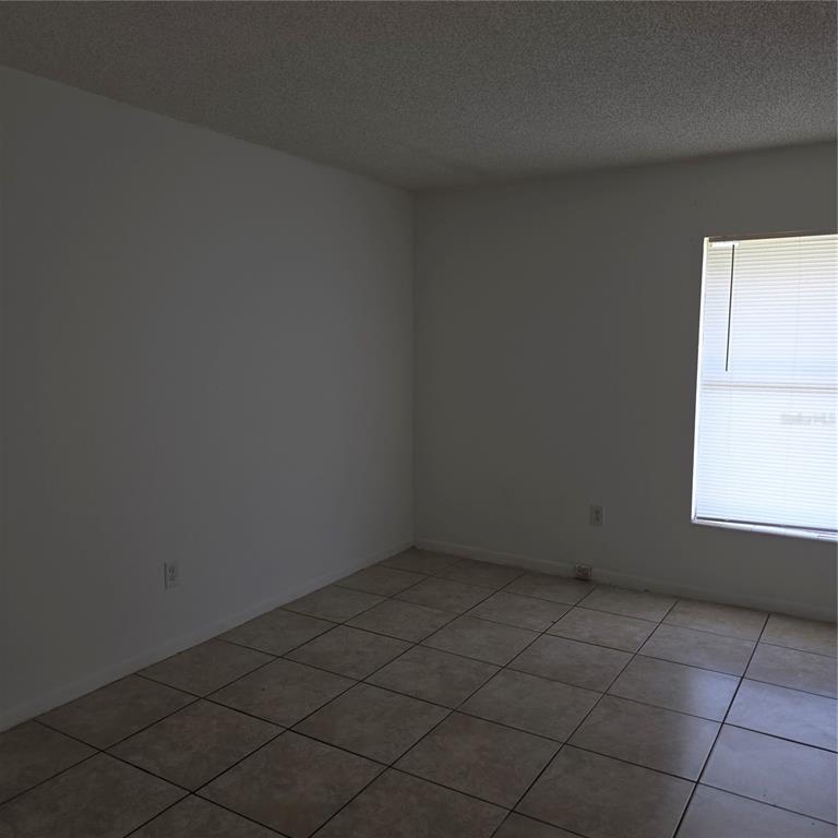 921 West Oak Ridge Road, Unit 921C Orlando, FL 32809 - Photo 6 of 6 an empty room with a window