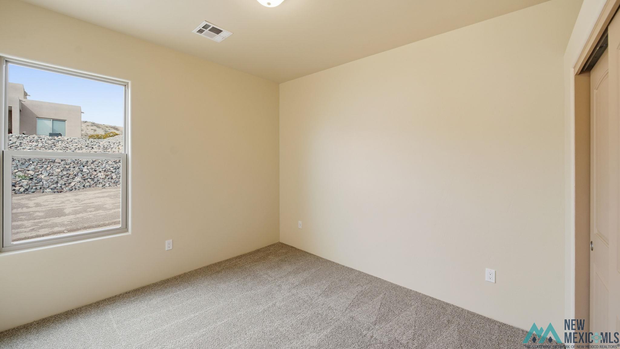 119 Mesa Grande Road Elephant Butte, NM 87935 - Photo 23 of 34 Empty room featuring carpet floors