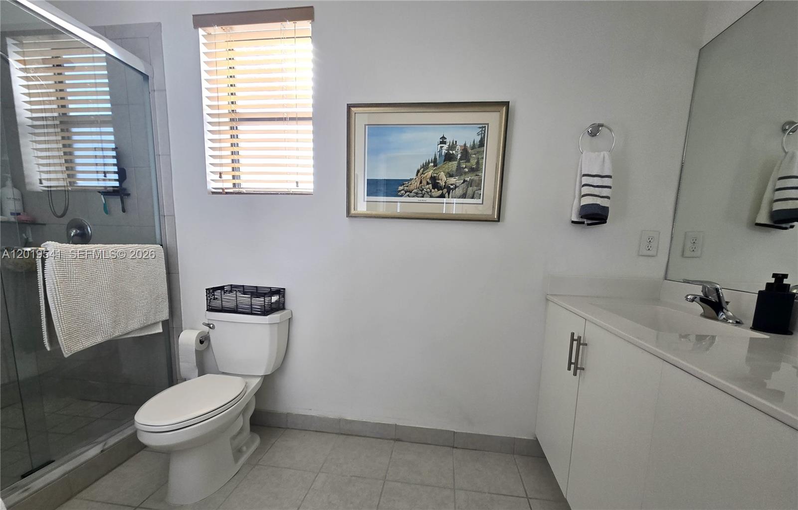 24400 Southwest 119th Place Homestead, FL 33032 - Photo 14 of 22 a white toilet sitting next to a bathroom sink