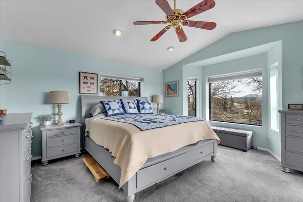 a bedroom with a large bed and a window