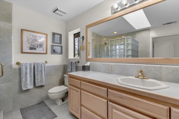 a bedroom with a bed and a mirror on the dresser