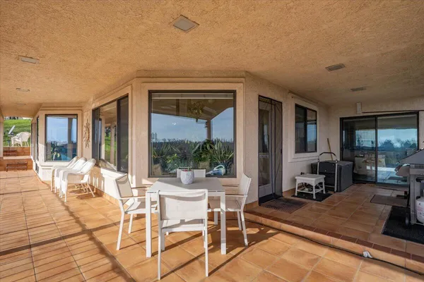 a view of a balcony with lake view and wooden floor