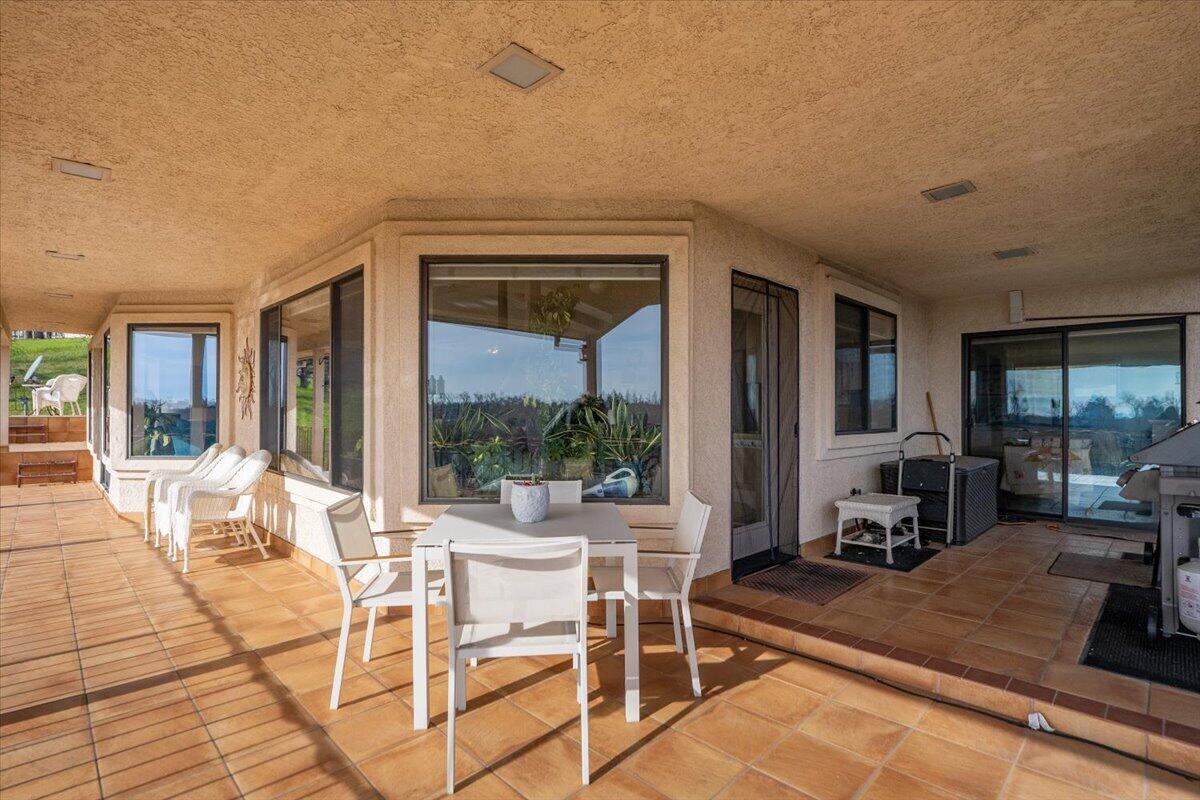 22560 Adobe Road Red Bluff, CA 96080 - Photo 29 of 49 a dining room with furniture and a floor to ceiling window