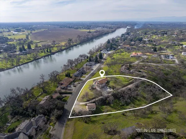 an aerial view of a house with a lake view