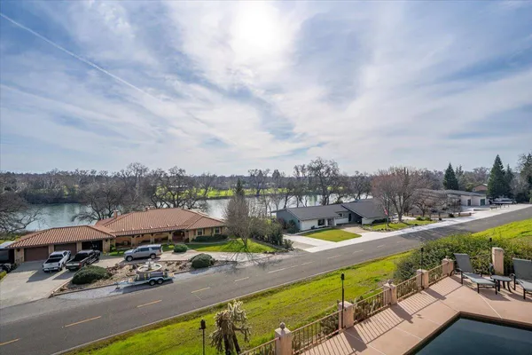 an aerial view of a house with a garden and lake view