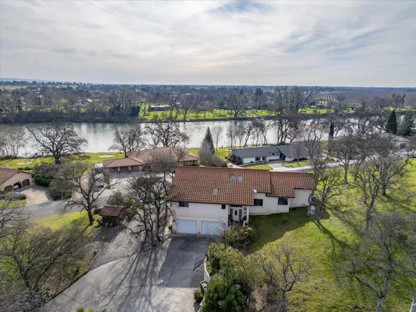 a view of a house with a yard and tree s