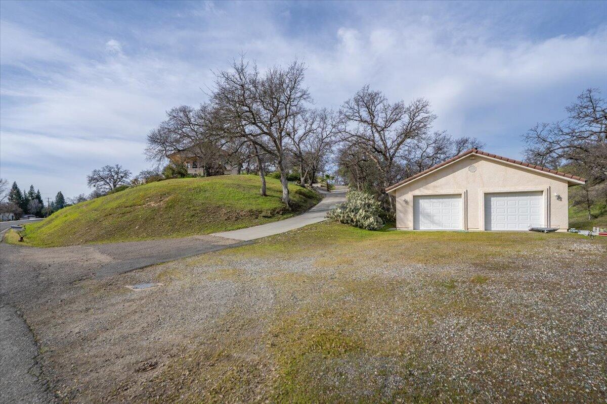 22560 Adobe Road Red Bluff, CA 96080 - Photo 40 of 48 a view of a house with a yard and garage
