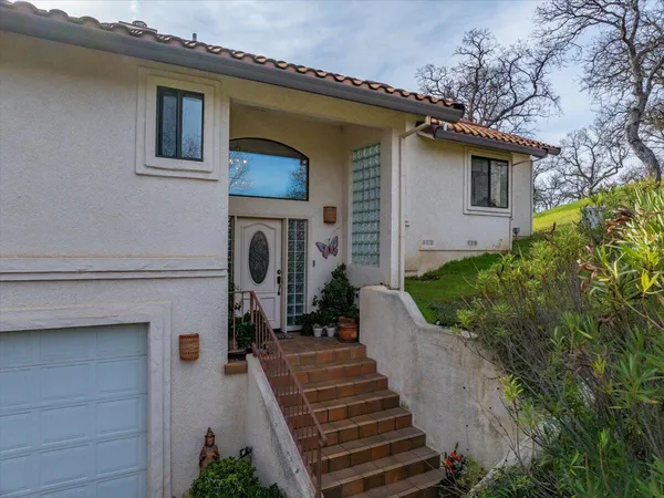 a view of a house with large windows and a pathway