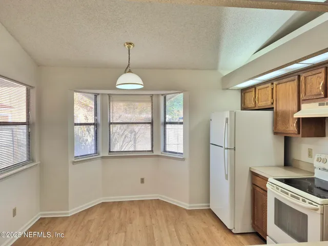 a kitchen with stainless steel appliances a stove a refrigerator and a sink