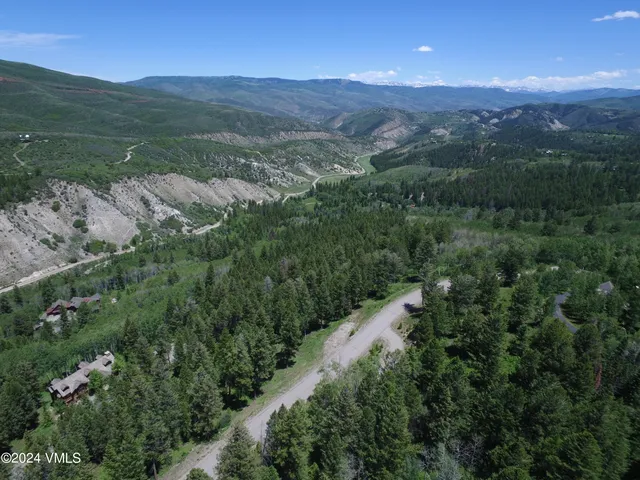 a view of a lush green hillside and houses