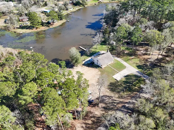 an aerial view of a house with a lake view