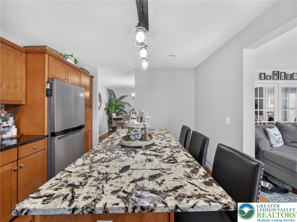 4148 Ross Road Bethlehem, PA 18020 - Photo 37 of 67 An inviting kitchen island features a granite countertop, offering a perfect spot for casual dining or entertaining.