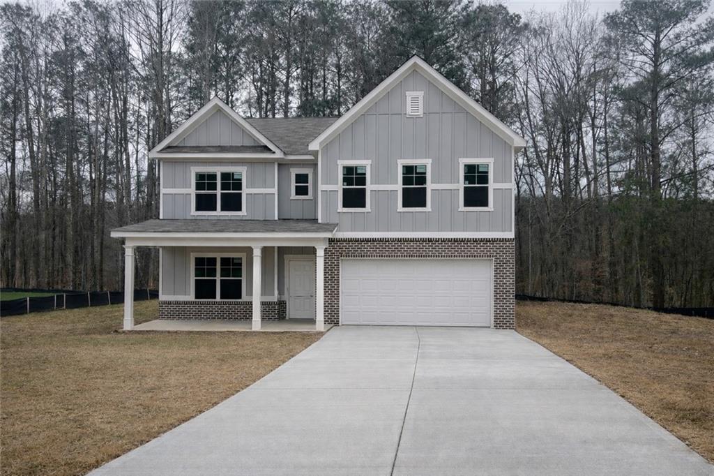 2719 Riverpine Trail Atlanta, GA 30331 - Photo 1 of 16 a front view of a house with a yard and garage