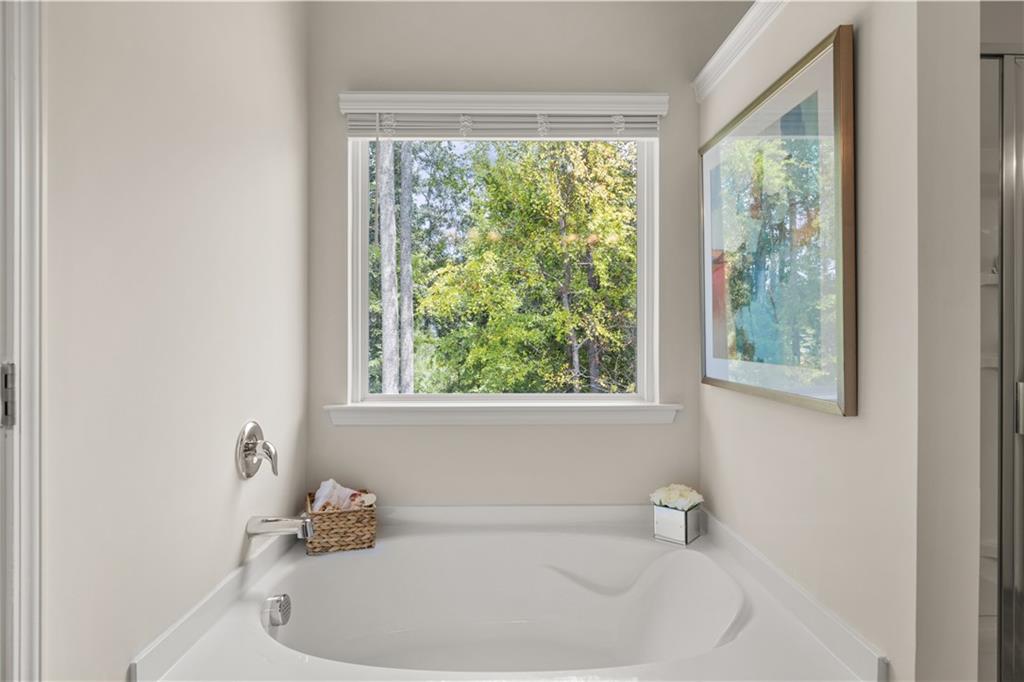 2719 Riverpine Trail Atlanta, GA 30331 - Photo 12 of 16 a white bath tub sitting in a bathroom next to a window
