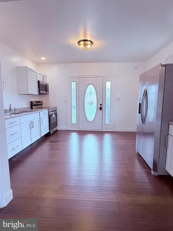 a view of a kitchen with a sink and a refrigerator