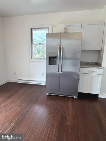 a living room with hard wood floors and a window
