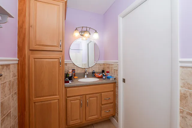 a bathroom with a sink a mirror and a vanity