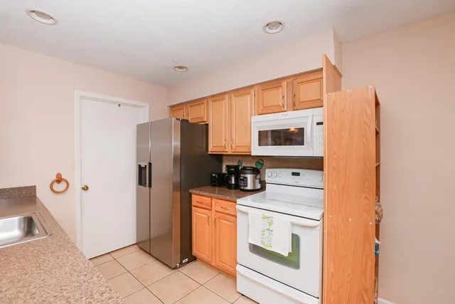 a kitchen with a stove top oven and refrigerator