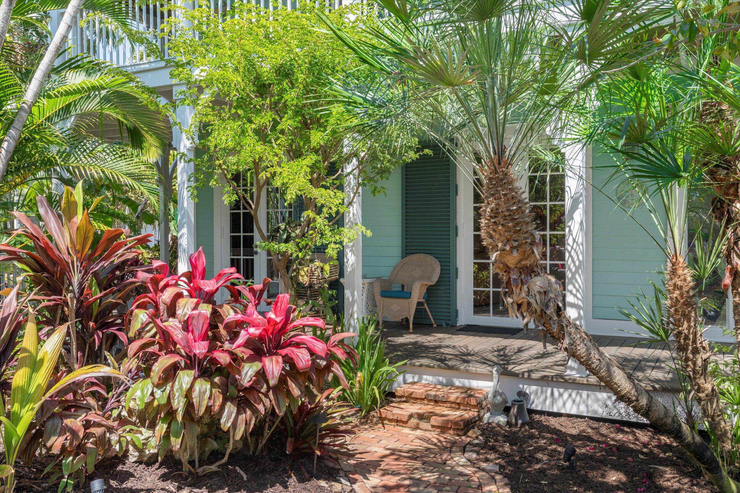 68 Sunset Key Drive Key West, FL 33040 - Photo 2 of 69 a front view of a house with a tree