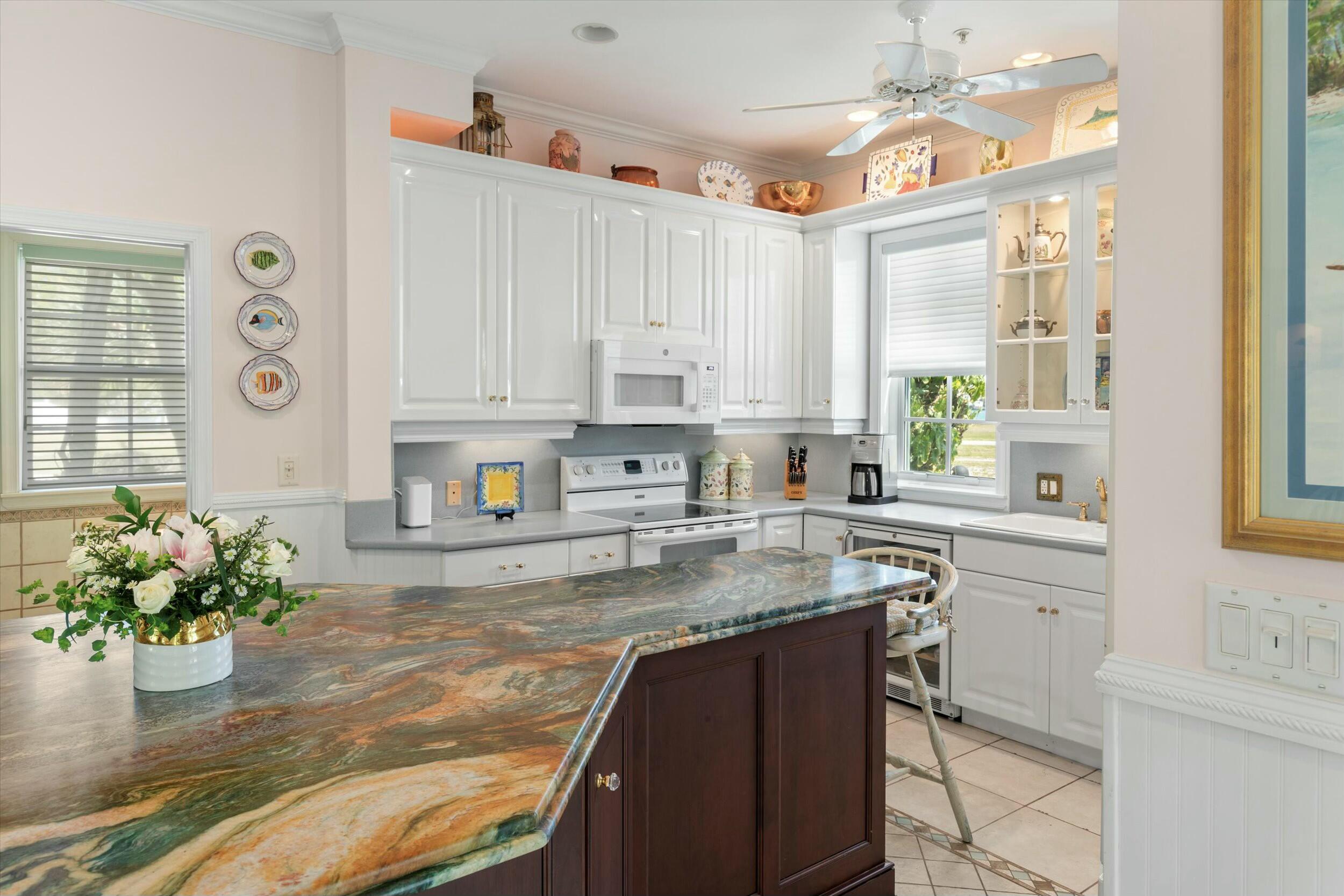 68 Sunset Key Drive Key West, FL 33040 - Photo 22 of 69 a kitchen with a white stove top oven and white cabinets